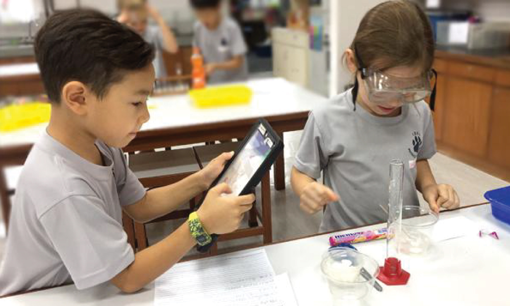 Elementary students experimenting with liquids in science class