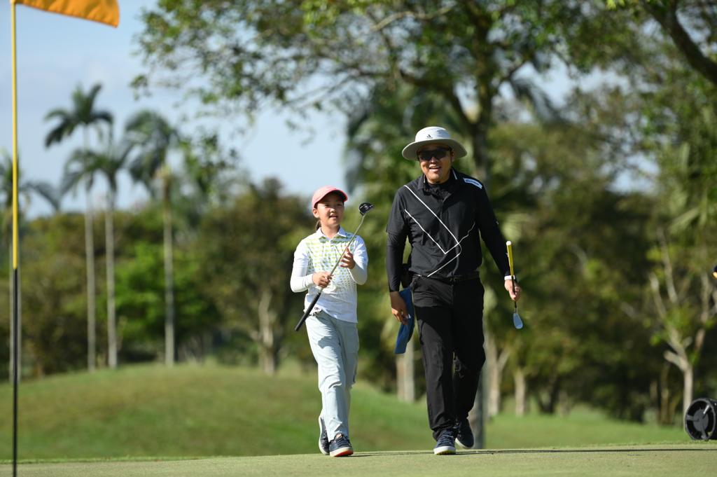 Jane and her dad at the golf course