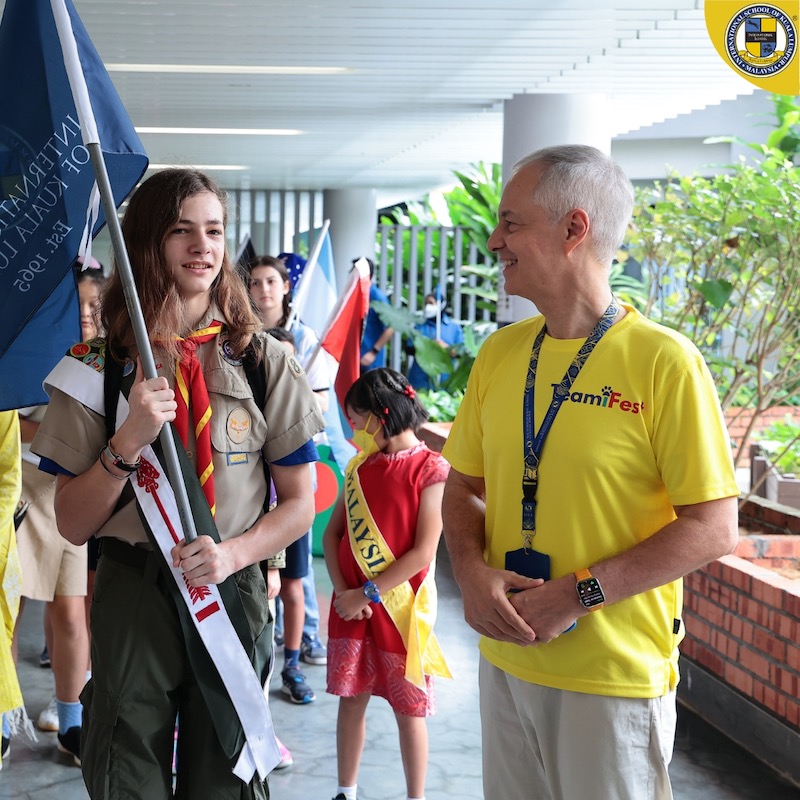 Rami talking to a student during International Fest